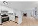 Modern kitchen with white cabinets, quartz countertops and stainless steel appliances at 12525 E Tennessee Cir # E, Aurora, CO 80012
