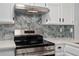 Modern kitchen features stainless steel appliances and hexagon backsplash at 12525 E Tennessee Cir # E, Aurora, CO 80012