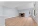 Living room with fireplace, hardwood floors, and access to patio at 12525 E Tennessee Cir # E, Aurora, CO 80012
