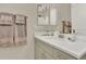 Neutral bathroom featuring double vanity with sink, stone countertop, and large mirror at 1982 Peralta Loop, Castle Rock, CO 80104