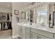 Bright bathroom featuring a double vanity and walk-in closet and modern lighting at 1982 Peralta Loop, Castle Rock, CO 80104