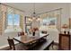 Charming dining room features a rustic wood table with bench seating and large windows with scenic views at 1982 Peralta Loop, Castle Rock, CO 80104
