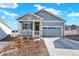 Charming one-story home with blue siding, covered porch, two car garage and manicured front yard at 1982 Peralta Loop, Castle Rock, CO 80104