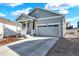 Charming one-story home with blue siding, covered porch, two car garage and manicured front yard at 1982 Peralta Loop, Castle Rock, CO 80104
