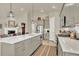 Bright kitchen boasts gray cabinets, stainless appliances, and a large island with light countertops at 1982 Peralta Loop, Castle Rock, CO 80104