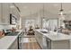 Open-concept kitchen features a large island, stainless steel appliances, and view to dining and living spaces at 1982 Peralta Loop, Castle Rock, CO 80104
