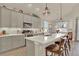 Modern kitchen features a large island with seating and stainless steel appliances and tile backsplash at 1982 Peralta Loop, Castle Rock, CO 80104
