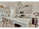 Modern kitchen features a large island with seating and stainless steel appliances, tile backsplash and custom cabinets at 1982 Peralta Loop, Castle Rock, CO 80104