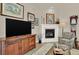 Cozy living room features a fireplace, large television, comfortable seating and attractive decor at 1982 Peralta Loop, Castle Rock, CO 80104