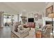 Inviting living room featuring hardwood floors, large windows, fireplace, and comfortable seating at 1982 Peralta Loop, Castle Rock, CO 80104