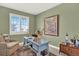 Bright office features a blue writing desk, large window, area rug, and serene decor at 1982 Peralta Loop, Castle Rock, CO 80104