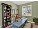 Bright office features a blue writing desk, shelving, area rug, and large window at 1982 Peralta Loop, Castle Rock, CO 80104