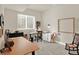 Bright office space includes a sewing machine, storage, a vintage chair, and large wood table at 1982 Peralta Loop, Castle Rock, CO 80104