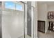 Modern bathroom with glass shower doors, neutral tile, and walk-in closet at 1982 Peralta Loop, Castle Rock, CO 80104