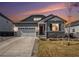 Charming single Gathering home with a well-manicured lawn, two car garage and stone accents at 22591 E Narrowleaf Cir, Aurora, CO 80016