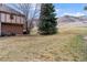 The large backyard features mature trees and a sprawling lawn, perfect for outdoor activities at 5 Tamarade Dr, Littleton, CO 80127