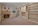 Cozy finished basement with fireplace, built-in shelves, cabinets, and carpeted floors at 5 Tamarade Dr, Littleton, CO 80127