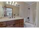Bathroom with granite counters, a long vanity, and a view into the shower and toilet at 5 Tamarade Dr, Littleton, CO 80127