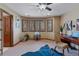 Bedroom with wooden shutters, desk, and ceiling fan at 5 Tamarade Dr, Littleton, CO 80127