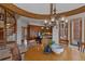 View of the dining room featuring a round wooden table with seating near a kitchen and spiral staircase at 5 Tamarade Dr, Littleton, CO 80127