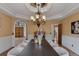 Formal dining room with decorative ceiling, stylish table setting, and doorway to the foyer and kitchen at 5 Tamarade Dr, Littleton, CO 80127