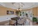 Elegant dining room with a modern chandelier, stylish table setting, and a walkout to the backyard at 5 Tamarade Dr, Littleton, CO 80127
