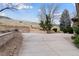 Concrete driveway, complimented by stone retaining walls and lush landscaping at 5 Tamarade Dr, Littleton, CO 80127