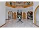 Grand foyer with marble floors, a striking staircase, and arched doorways leading to other rooms in the house at 5 Tamarade Dr, Littleton, CO 80127