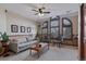 Comfortable living room boasts a decorative ceiling fan and large windows at 5 Tamarade Dr, Littleton, CO 80127