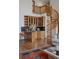 Wet bar featuring wood cabinetry, a granite countertop, and a spiral staircase in the background at 5 Tamarade Dr, Littleton, CO 80127