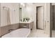 Modern bathroom with a freestanding tub, marble floors, and a sleek vanity at 2589 Arapahoe St, Denver, CO 80205