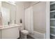 Bright bathroom featuring modern vanity, toilet, tub with shower and white subway tile at 2589 Arapahoe St, Denver, CO 80205