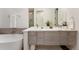 Elegant bathroom featuring double sinks, a marble countertop, and a soaking tub at 2589 Arapahoe St, Denver, CO 80205