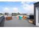 Relaxing rooftop deck with outdoor seating, a barbecue grill, and city views at 2589 Arapahoe St, Denver, CO 80205