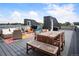 Inviting rooftop deck with outdoor seating, a dining table, and a barbecue grill at 2589 Arapahoe St, Denver, CO 80205