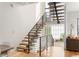 Modern staircase with hardwood steps and black metal railing, open to the upper level at 2589 Arapahoe St, Denver, CO 80205