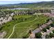 Stunning aerial view showcases the neighborhood's scenic surroundings with a lake, walking paths, and beautiful greenery at 5750 S Youngfield St, Littleton, CO 80127