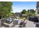 Relaxing backyard deck featuring comfortable seating, a fire table, and a grill, perfect for outdoor entertainment at 5750 S Youngfield St, Littleton, CO 80127
