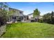 Expansive backyard with a well-maintained lawn, patio, deck, and mature trees creating a private outdoor oasis at 5750 S Youngfield St, Littleton, CO 80127