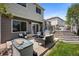 The backyard patio showcases outdoor seating, a deck with steps, a lush lawn, and direct access to the home at 5750 S Youngfield St, Littleton, CO 80127