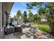 Inviting backyard patio features outdoor seating, a lush lawn, mature trees, and a tranquil setting for relaxation at 5750 S Youngfield St, Littleton, CO 80127