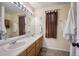 Bathroom featuring a double sink vanity with two large mirrors and ample space for daily routines at 5750 S Youngfield St, Littleton, CO 80127