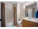 Standard bathroom with shower-tub combo, a single sink vanity with tile flooring at 5750 S Youngfield St, Littleton, CO 80127