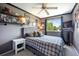 Comfortable bedroom with sports-themed decor, including sports memorabilia on shelves, and a mounted television at 5750 S Youngfield St, Littleton, CO 80127