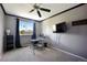 Spare bedroom featuring neutral gray walls, a large window, and a sleek computer desk and chair setup at 5750 S Youngfield St, Littleton, CO 80127