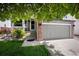 Charming two-story home with attached garage and inviting front yard, shaded by a large tree at 5750 S Youngfield St, Littleton, CO 80127