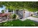 Inviting home exterior with brick accents, well-maintained lawn, and an attached two-car garage at 5750 S Youngfield St, Littleton, CO 80127