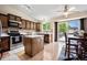 Well-appointed kitchen featuring stainless steel appliances, central island, and wood-paneled cabinets at 5750 S Youngfield St, Littleton, CO 80127