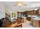 Open kitchen layout showcasing wood cabinets, stainless steel appliances, and a dining area with natural light at 5750 S Youngfield St, Littleton, CO 80127