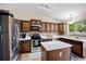 Modern kitchen with stainless steel appliances, white countertops, and wood cabinets with a central island at 5750 S Youngfield St, Littleton, CO 80127